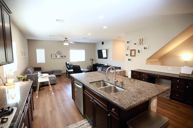 kitchen featuring sink, hardwood / wood-style flooring, ceiling fan, an island with sink, and stainless steel appliances