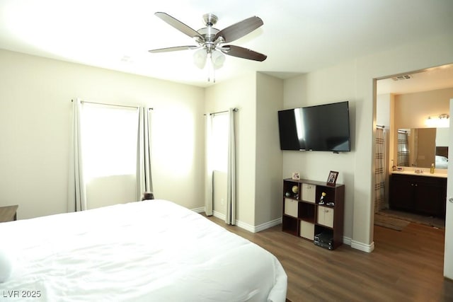 bedroom featuring ceiling fan, dark wood-type flooring, and ensuite bathroom