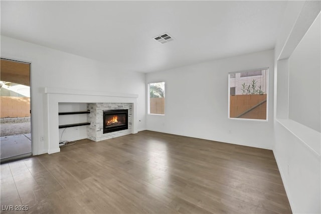 unfurnished living room with a fireplace and hardwood / wood-style flooring