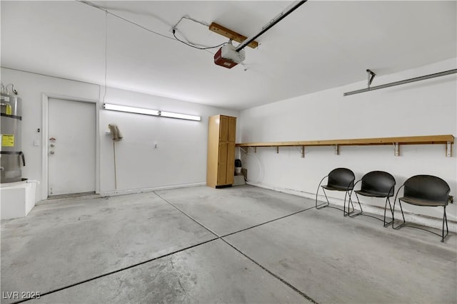 garage with secured water heater and a garage door opener