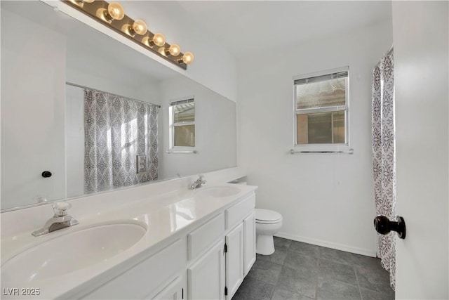 bathroom featuring vanity, toilet, and walk in shower