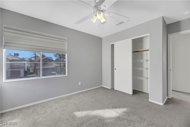 unfurnished bedroom featuring carpet, a closet, and ceiling fan