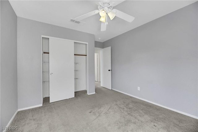 unfurnished bedroom with carpet, ceiling fan, and a closet