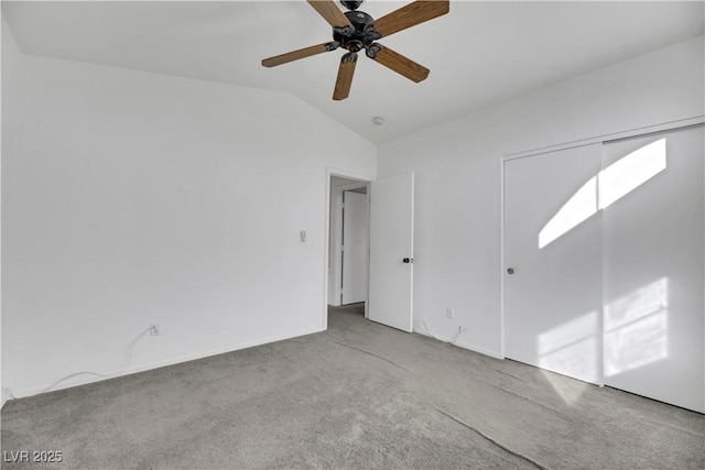 unfurnished room with ceiling fan, light carpet, and vaulted ceiling