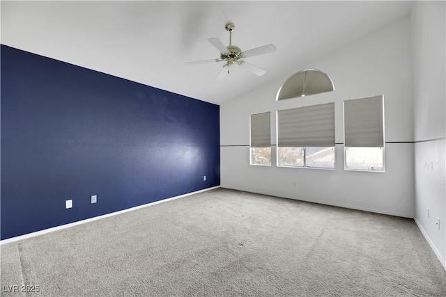 carpeted empty room with ceiling fan and lofted ceiling