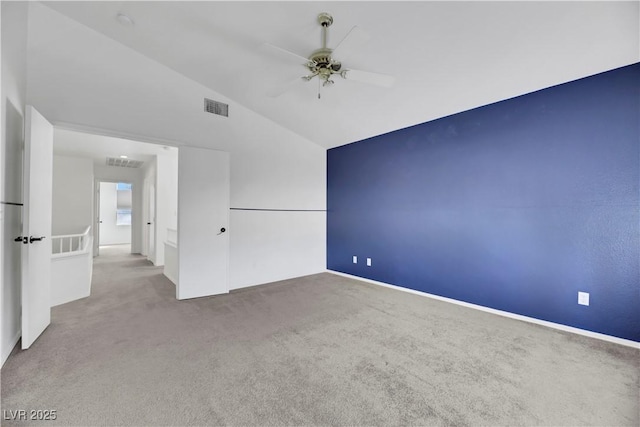 empty room featuring carpet flooring, ceiling fan, and vaulted ceiling