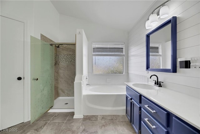 bathroom featuring tile patterned flooring, vanity, independent shower and bath, and lofted ceiling