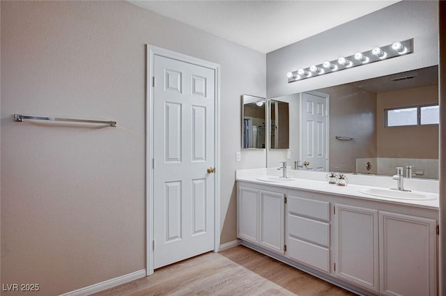 bathroom with hardwood / wood-style floors and vanity