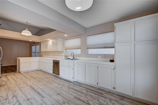 kitchen featuring dishwasher, sink, hanging light fixtures, light hardwood / wood-style flooring, and white cabinets