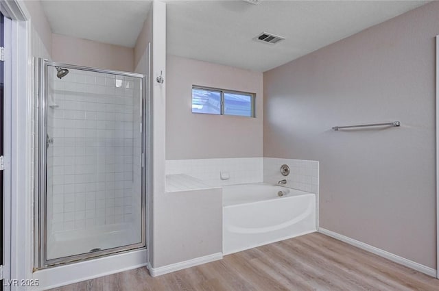 bathroom featuring separate shower and tub and wood-type flooring