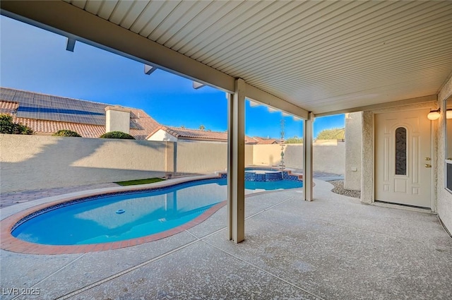 view of pool with an in ground hot tub and a patio area