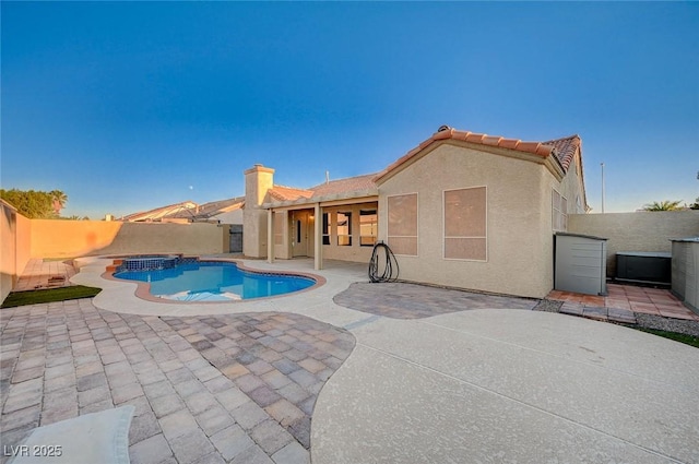 view of pool with an in ground hot tub and a patio area