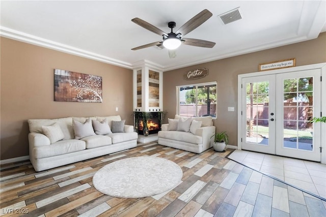 living room featuring french doors and ceiling fan