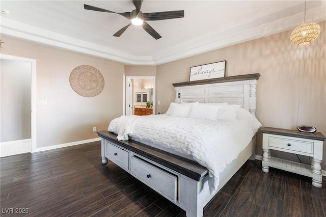 bedroom featuring a raised ceiling and ceiling fan