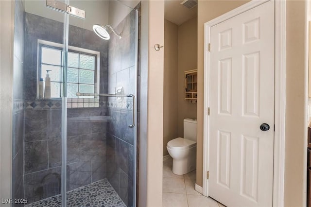 bathroom featuring toilet, tile patterned floors, and an enclosed shower