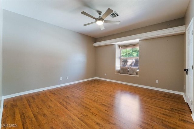 empty room with ceiling fan and hardwood / wood-style flooring