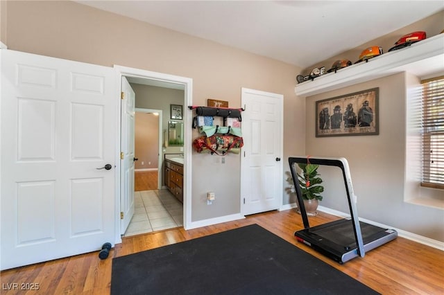 exercise area with light hardwood / wood-style floors