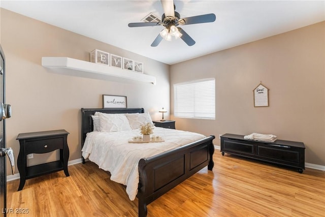 bedroom with ceiling fan and light hardwood / wood-style floors