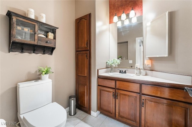 bathroom featuring tile patterned flooring, vanity, and toilet