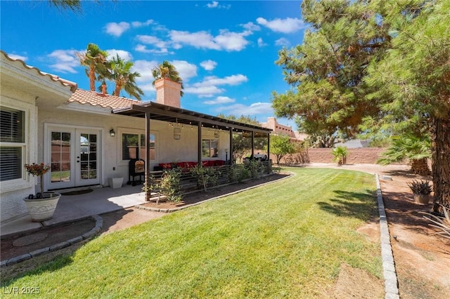 view of yard featuring french doors and a patio area