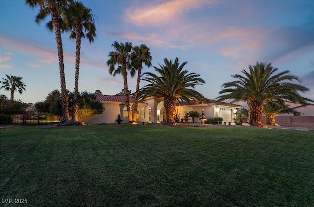 mediterranean / spanish house with a lawn