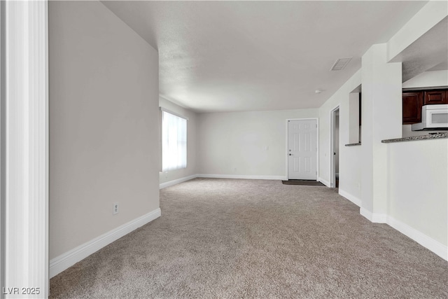 unfurnished living room featuring light colored carpet