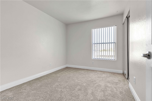 unfurnished room with light carpet