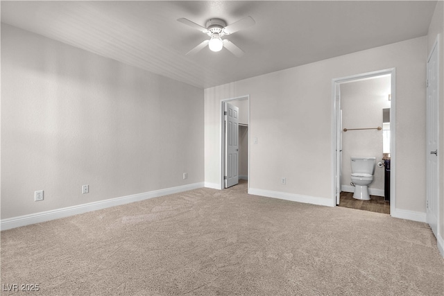 unfurnished bedroom with carpet, ceiling fan, a spacious closet, connected bathroom, and a closet