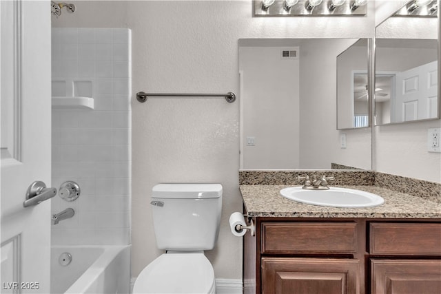 full bathroom with vanity,  shower combination, toilet, and ceiling fan