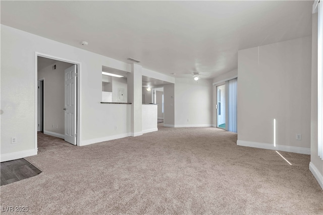 unfurnished living room with light carpet and ceiling fan