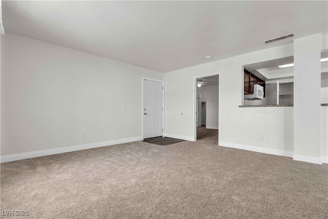 spare room featuring carpet floors and ceiling fan