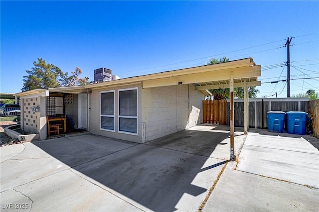 rear view of house with a patio area and central AC