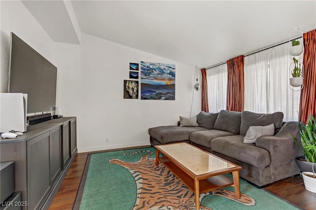 living room with dark wood-type flooring and lofted ceiling