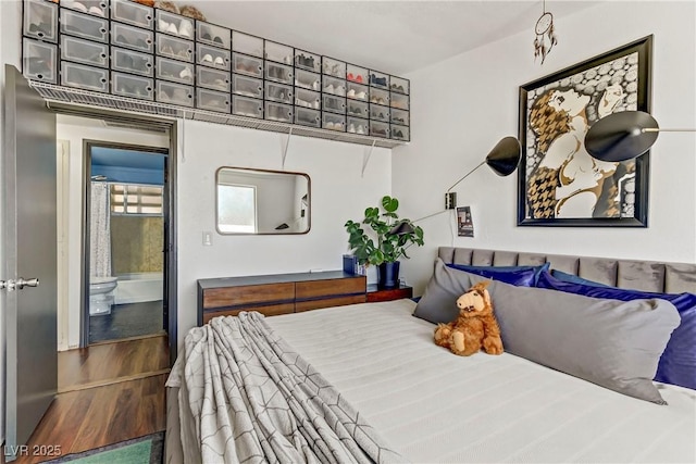 bedroom with hardwood / wood-style floors and a mail area