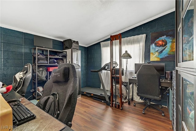 home office featuring lofted ceiling and wood-type flooring