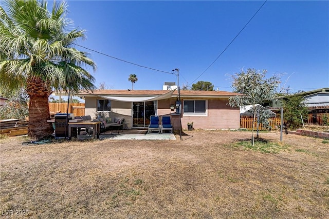 rear view of property featuring a patio area