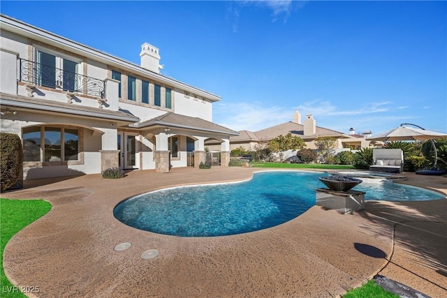 view of swimming pool featuring a patio area