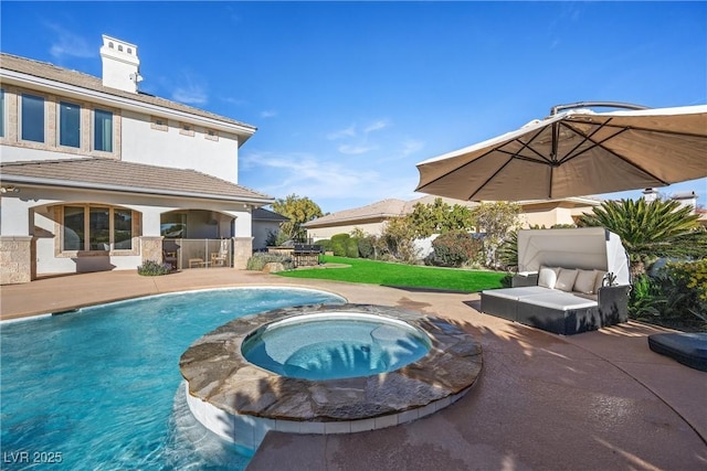 view of swimming pool featuring a patio area and an in ground hot tub