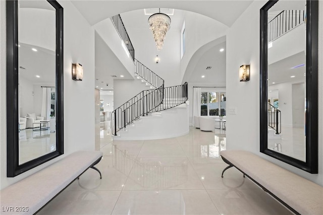 tiled foyer entrance featuring a chandelier