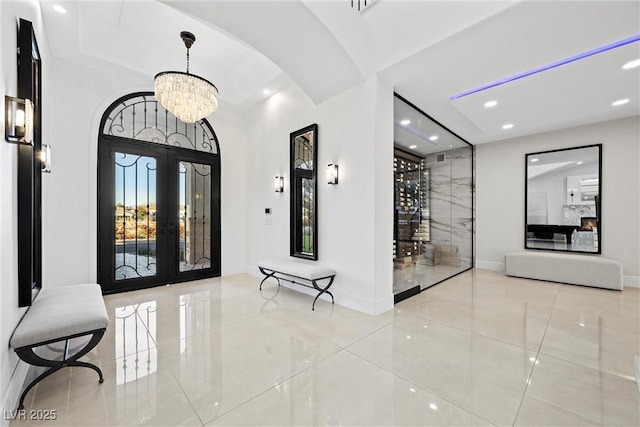 entrance foyer with french doors and an inviting chandelier