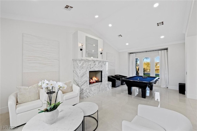 game room with a premium fireplace, vaulted ceiling, crown molding, and billiards