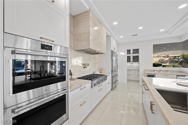 kitchen with light tile patterned flooring, white cabinetry, and stainless steel appliances