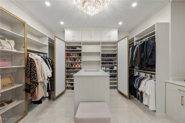 spacious closet with light tile patterned floors and a chandelier