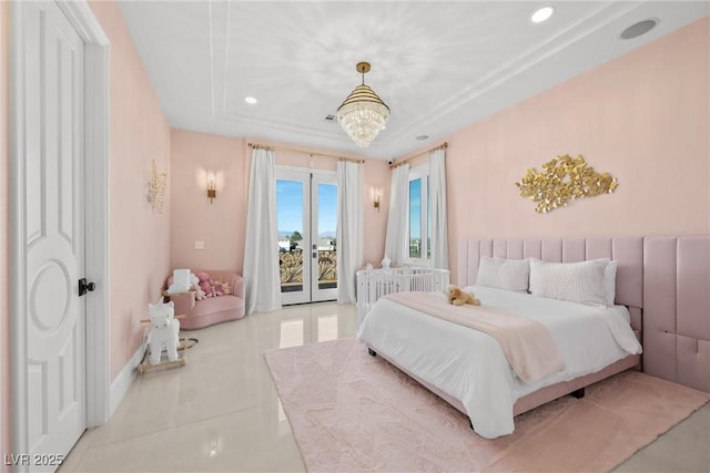 bedroom with access to outside, a tray ceiling, a chandelier, and light tile patterned floors