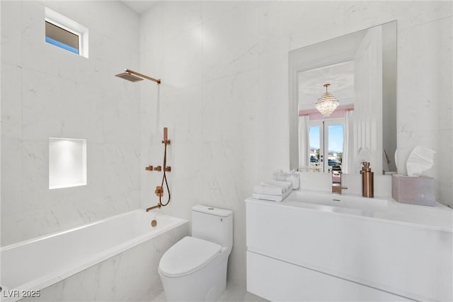 bathroom with a notable chandelier, vanity, and toilet