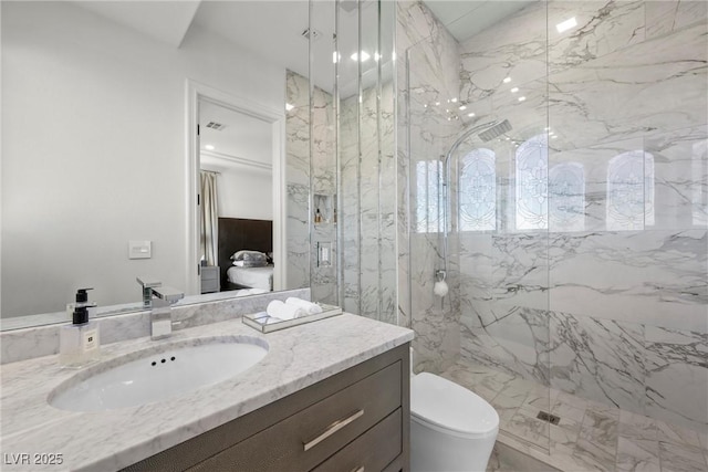 bathroom featuring vanity, toilet, and a tile shower