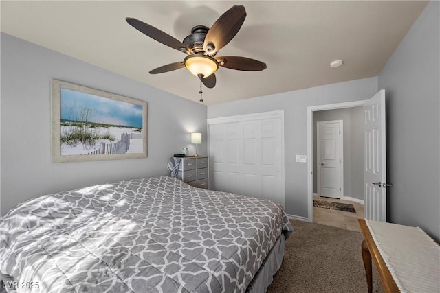 bedroom with ceiling fan, a closet, and carpet flooring