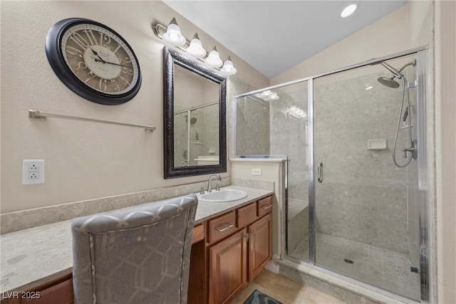 bathroom with lofted ceiling, tile patterned floors, an enclosed shower, and vanity