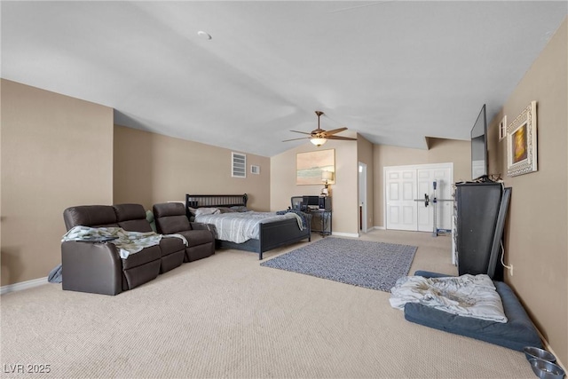 bedroom with ceiling fan, light colored carpet, and lofted ceiling