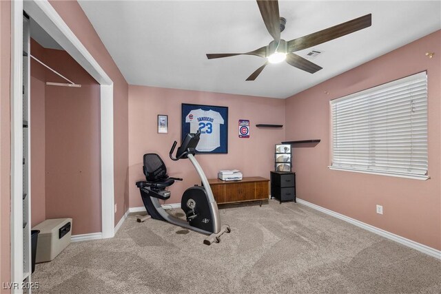 exercise area with ceiling fan and light carpet